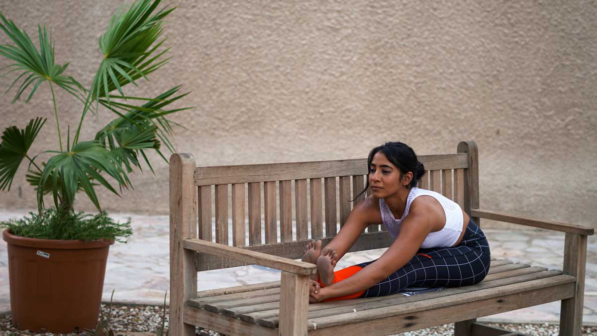 Nilaya House - Intro to Ashtanga Yoga Course - Zainab Hafizji practicing yoga on a bench